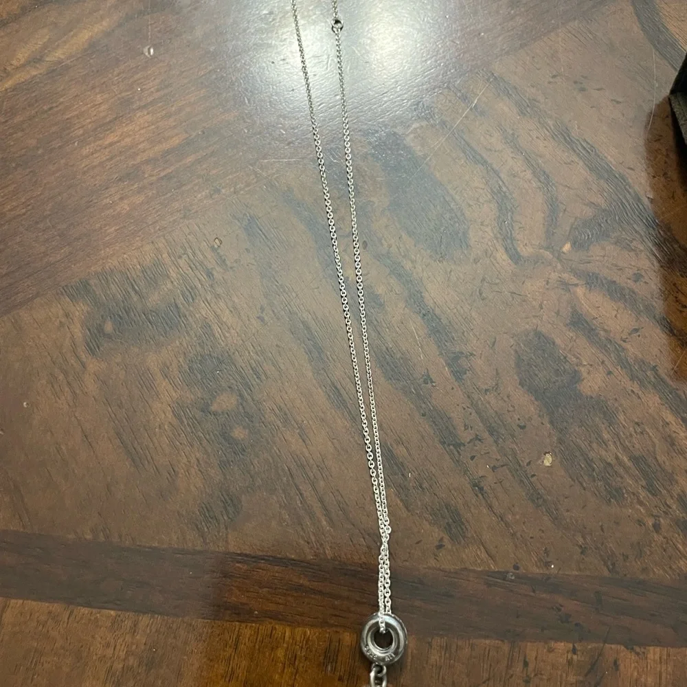 Silver necklace with a circle at end and pacifier at end of circle - Picture 5 of 6